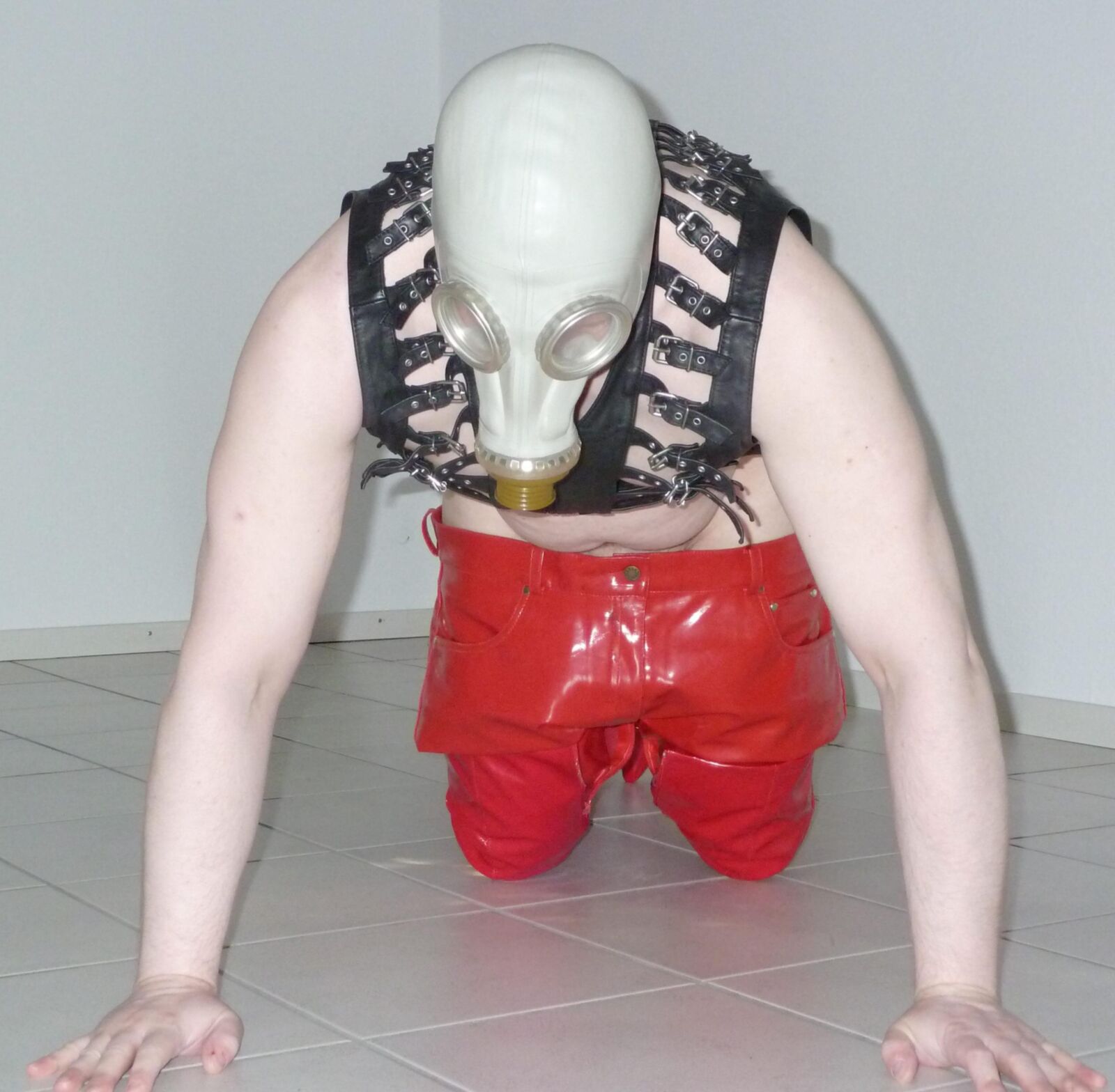 Gas mask and red shiny pants