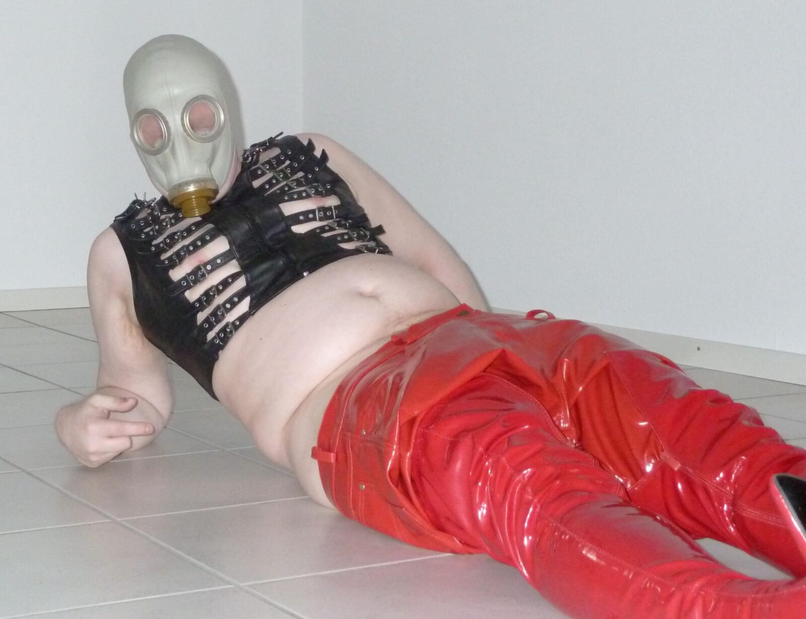Gas mask and red shiny pants